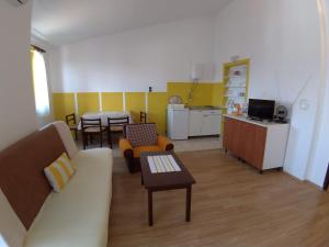 a living room with a couch and a table at Apartments Beceic in Njivice