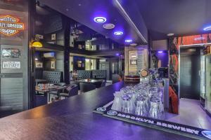 a bar with a row of empty vodka bottles at Resort Hotel Elija in Šventoji