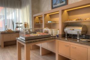 a kitchen with a counter with food on it at Hotel Garni Losanna in Bibione