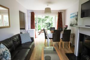 a living room with a couch and a table at Bunratty Castle Gardens Home in Bunratty