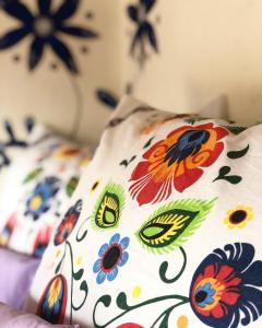 a pillow with flowers on it sitting on a bed at Folklórna chyža in Bojnice