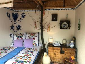 a bedroom with a bed and a wooden dresser at Folklórna chyža in Bojnice