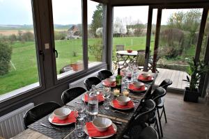 a table in a room with a view of a field at Les Hauts de Crupet in Maillen