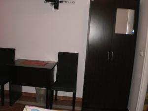 a bedroom with a black desk and a black cabinet at Rooms Lutra in Bilje
