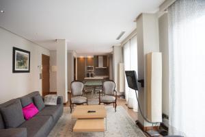 a living room with a couch and a table at Niza La Concha - IB. Apartments in San Sebastián