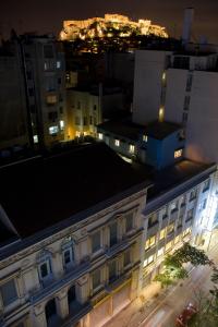 a view of a building in a city at night at Arethusa Hotel in Athens