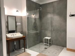 a bathroom with a sink and a shower at La Charuel in Épernay