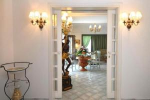 a living room with a woman standing in the doorway at Albergo La Conca Azzurra in Conca dei Marini