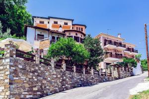 a building on top of a stone wall at Golden Sun in Agios Ioannis Pelio