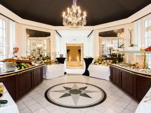 a chef preparing food in a large room at Excelsior Hotel Ernst am Dom in Cologne