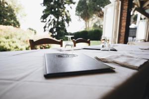 a table with a book on top of it at Cascina Speranza Hotel in Riva presso Chieri