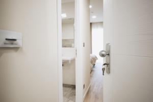 a door leading into a room with a bathroom at Cascina Speranza Hotel in Riva presso Chieri