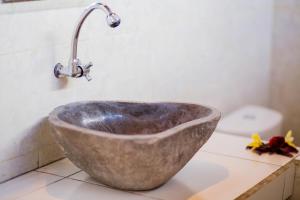 a bathroom sink with a faucet on a counter at Mimpi Cottages in Nusa Lembongan