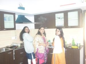 een groep van drie vrouwen in een keuken bij Holidays and Celebrations in Kodaikānāl