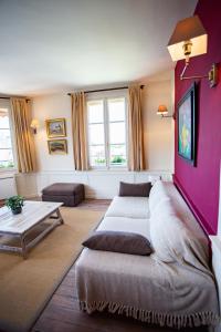 a living room with a couch and a table at Appartement Vieux Bassin in Honfleur