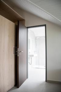 an open door to a bathroom with a sink at Penzion Šafrán in Jeseník