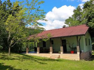 a small green house with a red roof at Private place, Boca in Bihać