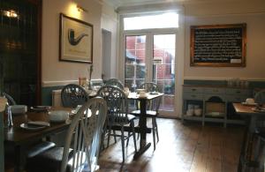 a dining room with a table and chairs and a window at The Telstar in Exeter