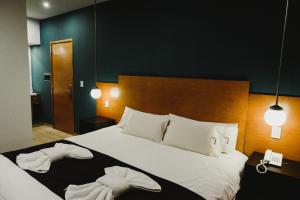 Cama ou camas em um quarto em Plaza Paradiso Petit Hotel