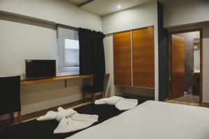 Cama ou camas em um quarto em Plaza Paradiso Petit Hotel