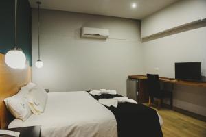 Cama ou camas em um quarto em Plaza Paradiso Petit Hotel