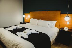 Cama ou camas em um quarto em Plaza Paradiso Petit Hotel