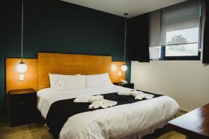 Cama ou camas em um quarto em Plaza Paradiso Petit Hotel