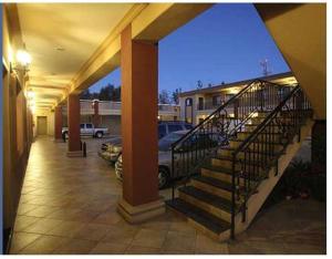 a staircase in a building with cars in a parking lot at Hotel Plaza las Quintas in Hermosillo