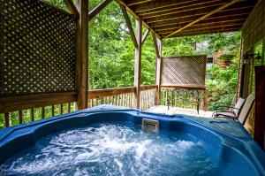 a hot tub in a gazebo on a porch at Asheville Cabins of Willow Winds in Asheville