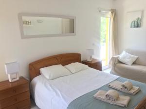 a bedroom with a bed with two towels on it at Vilamoura Cosy Central Flat in Vilamoura