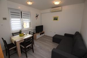 a living room with a couch and a table at Apartment Ćukušić in Split +19 photos