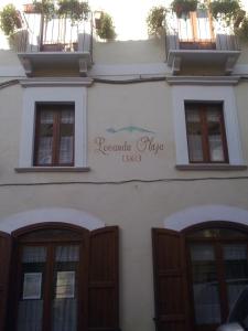 a building with three windows and a sign on it at Locanda Maja B&B in Guardiagrele