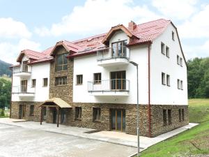 a large white building with a red roof at EFI ApartHotel Horní Lipová in Lipova Lazne