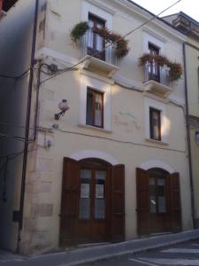 a white building with wooden doors and windows at Locanda Maja B&B in Guardiagrele