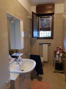 a bathroom with a white sink and a toilet at bed and breakfast IMOLA in Imola