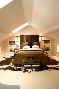 a bedroom with a large bed and a large rug at Bourgogne Suite Maastricht in Maastricht