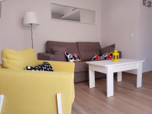 a living room with a couch and a table at Apartamentos Los Corralejos in Fuengirola