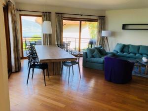 a living room with a couch and a table and chairs at Angel Services - Le Vivier in Talloires +17 photos