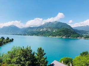 a view of a lake with mountains in the background at Angel Services - Le Vivier in Talloires