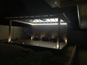 a pavilion with chairs and lights in the dark at Relaxed Ocean View in Mandurah