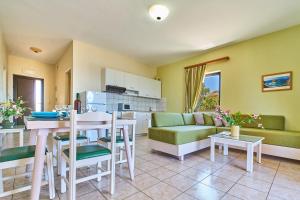 a kitchen and living room with a table and a couch at Nanakis Beach Apartments in Stavros