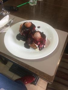 a white plate of food on a table at Provincial in Vişeu de Jos