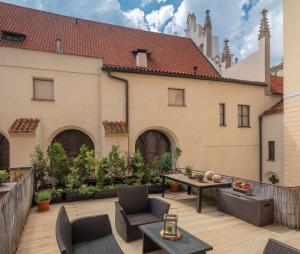 een terras met stoelen en tafels en een gebouw bij Mordecai 12 Apartments by Adrez in Praag