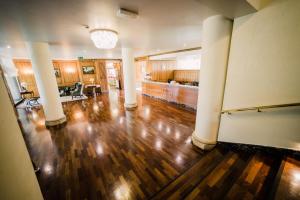 an empty living room with a hard wood floor at Versilia Golf Resort in Forte dei Marmi