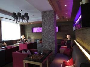a restaurant with couches and tables in a room at Wolfs Aparts + More in Ischgl