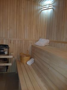 a sauna with a bed and a wooden floor at Trenchova Guest House in Bansko