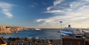 a large cruise ship docked in a harbor at CampuSpace in Cagliari
