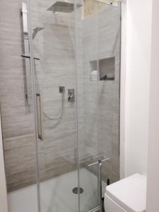 a shower with a glass door in a bathroom at Residenza Bagolino in Alcamo