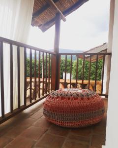 a large ottoman sitting on the balcony of a house at la casa de la nona in San Gil