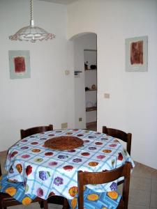 a table with a quilt on it in a room at Alloggio Basilico in Diano San Pietro